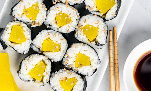 Round sushi pieces filled with bright yellow radish