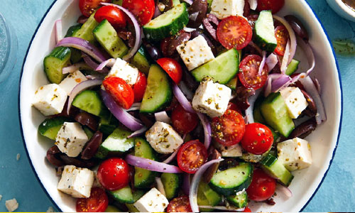 Fresh green salad with tomatoes olives and soft white cheese